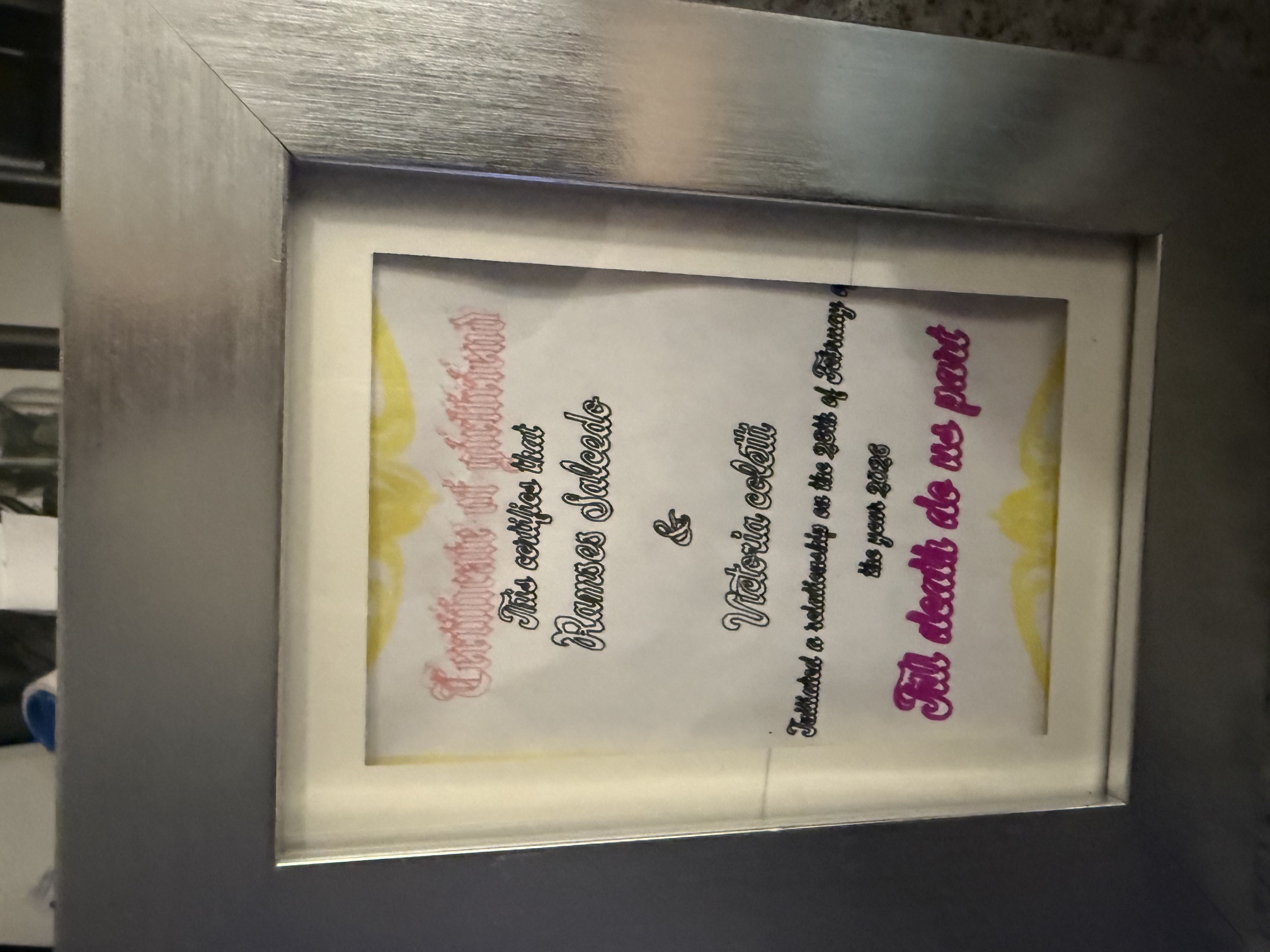 Framed relationship certificate marking February 28 and the promise till death do us part