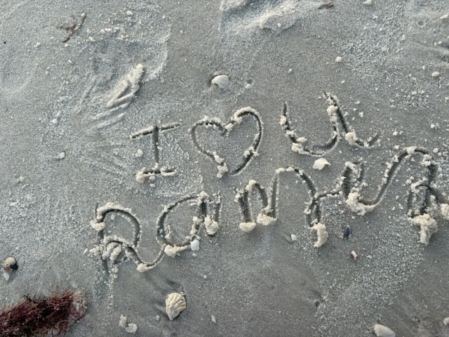 Our initials and hearts written together in the sand during our Naples trip